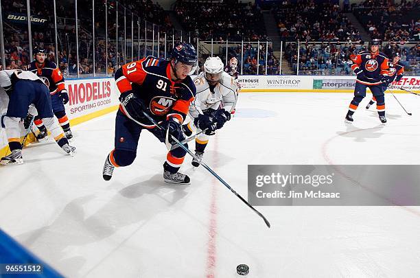 John Tavares of the New York Islanders skates against Joel Ward of the Nashville Predators on February 9, 2010 at Nassau Coliseum in Uniondale, New...