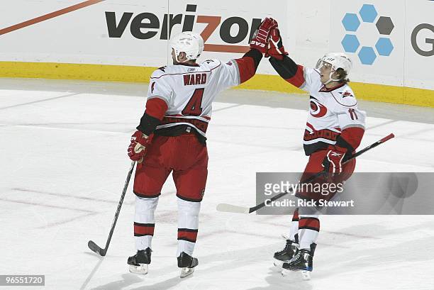 Aaron Ward of the Carolina Hurricanes celebrates with Zach Boychuk during the game against the Buffalo Sabres at HSBC Arena on February 5, 2010 in...