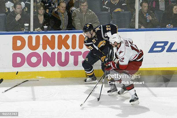 Eric Staal of the Carolina Hurricanes skates for the puck against Drew Stafford of the Buffalo Sabres at HSBC Arena on February 5, 2010 in Buffalo,...