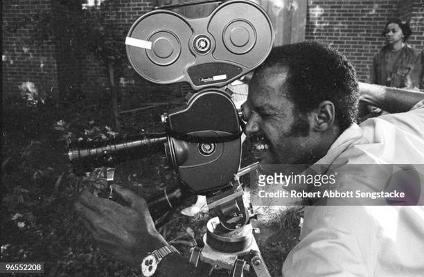 Photographer Robert Abbott Sengstacke looks through the film camera while assisting on the set of one of Carlton Moss' films, Nashville, 1972....