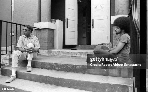 On the left, film director Carlton Moss is seated during a break from filming, Nashville, TN, 1972. On the right is an unidentified student from Fisk...