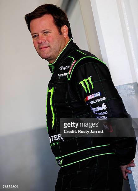 Robby Gordon, driver of the Monster Energy Toyota, stands in the garage during practice for the NASCAR Sprint Cup Series Daytona 500 at Daytona...