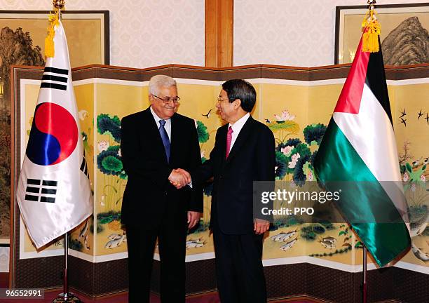 In this handout image supplied by the Palestinian Press Office , Palestinian President Mahmoud Abbas shakes hands with Korean Prime Minister Han...