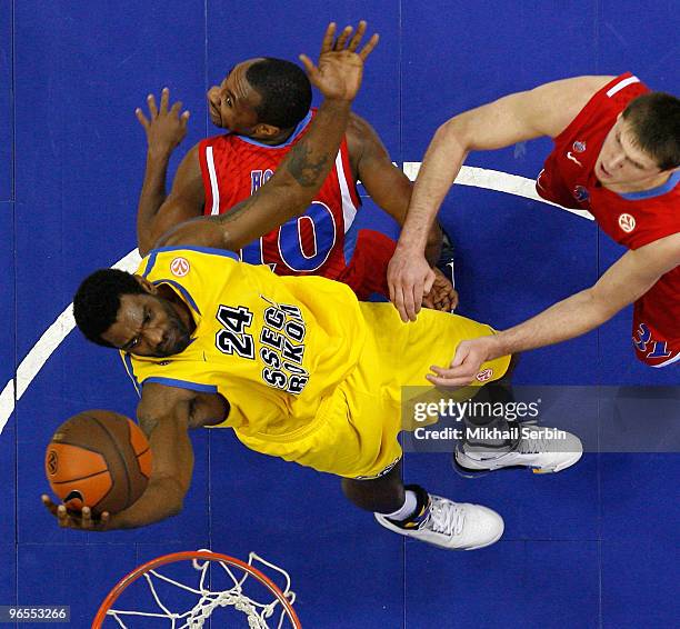 Qyntel Woods, #24 of Asseco Prokom Gdynia competes with J.R. Holden, #10 and Viktor Khryapa, #31 of CSKA Moscow during the Euroleague Basketball...