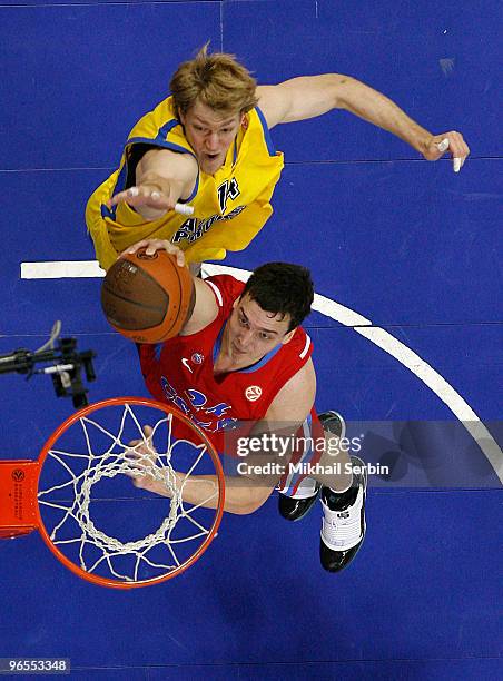 Sasha Kaun, #24 of CSKA Moscow competes with Jan-Hendrick Jagla, #14 of Asseco Prokom Gdynia during the Euroleague Basketball 2009-2010 Last 16 Game...