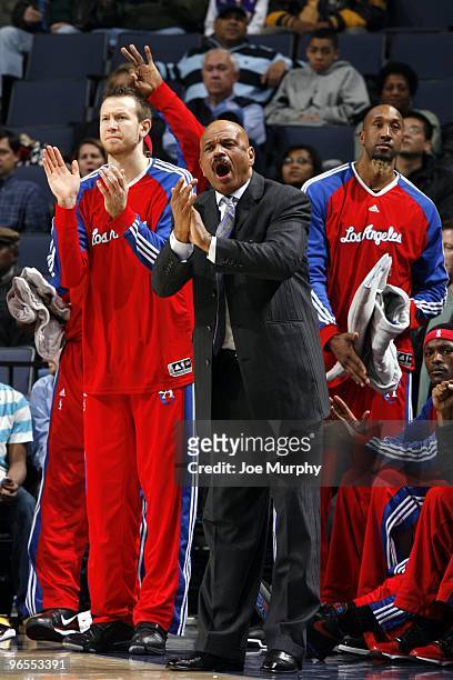 Steve Novak, assistant coach John Lucas II and Brian Skinner of the Los Angeles Clippers cheer on their teammates from the sideline during the game...