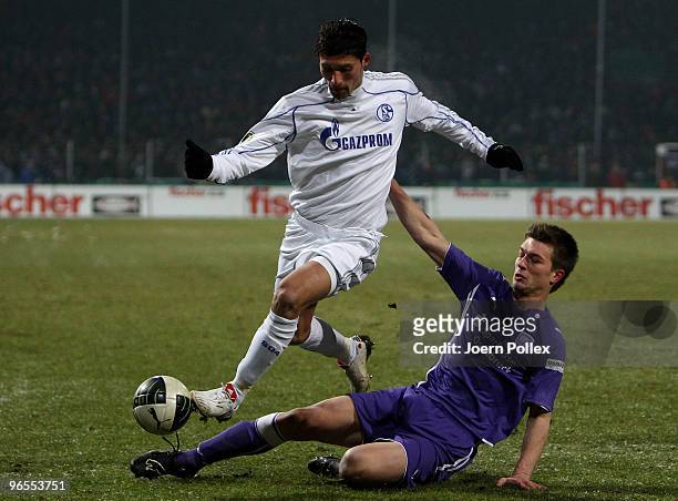 Kevin Kuranyi of Schalke and Oliver Stang of Osnabrueck battle for the ball during the DFB Cup quarter final match between VfL Osnabrueck and FC...