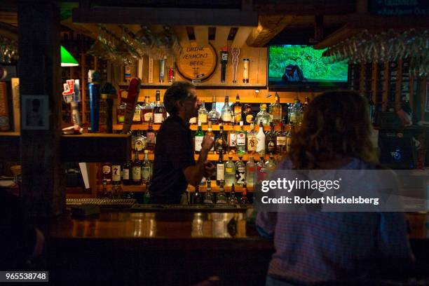 Bartender serves customers May 23, 2018 at the Basin Harbor Resort in Vergennes, Vermont.