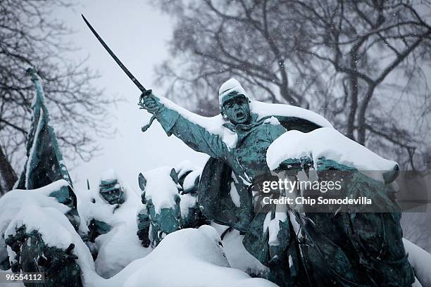 Snow covers a statue depicting warriros from the Civil War on the grounds of the U.S. Capitol during a powerful winter storm February 10, 2010 in...