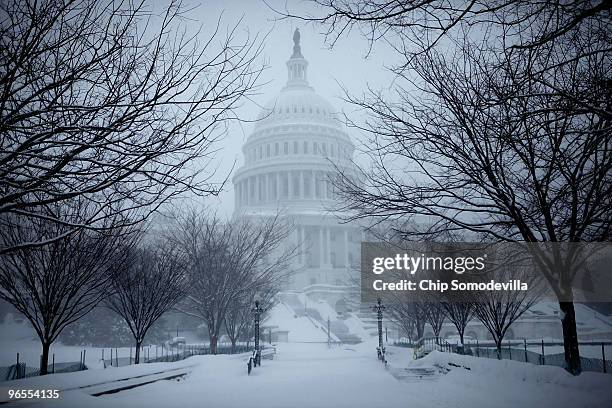 Blowing snow obscures the U.S. Capitol during a powerful winter storm February 10, 2010 in Washington, DC. The capital area was crippled Wednesday...