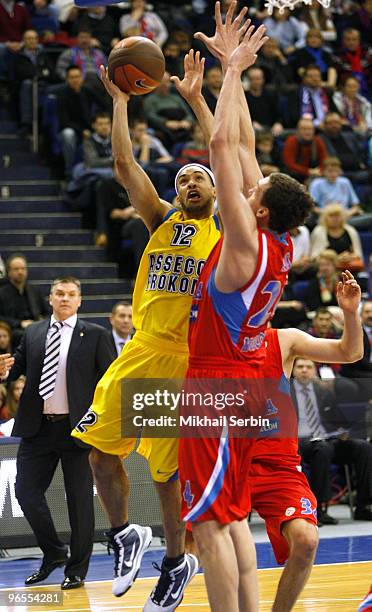 David Logan, #12 of Asseco Prokom Gdynia competes with Sasha Kaun, #24 of CSKA Moscow during the Euroleague Basketball 2009-2010 Last 16 Game 3...