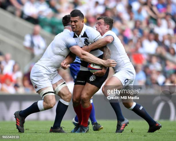 Josh Matavesi of the Barbarians is tackled by England's Tom Curry and George Ford during the Quilter Cup match between England and Barbarians at...