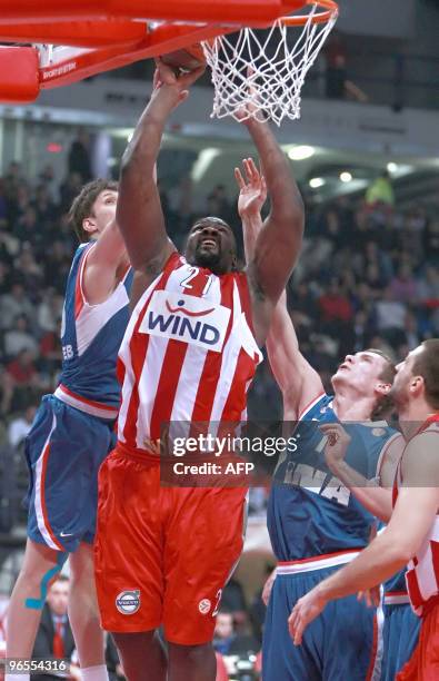 Olympiacos' Sofoklis Schortsanitis jumps to score next to Vedran Vukusic of Cibona Zagreb during their Euroleague top 16 basketball game in Athens on...