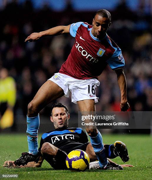 Ryan Giggs of Manchester United battles with Fabian Delph of Aston Villa during the Barclays Premier League match between Aston Villa and Manchester...