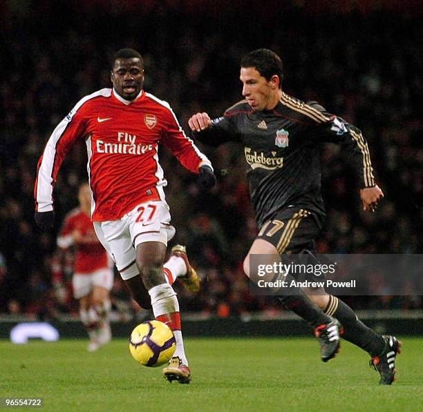 Maxi Rodriguez of Liverpool competes with Emmanuel Eboue of Arsenal during the Barclays Premier League match between Arsenal and Liverpool at...