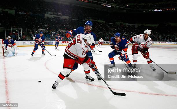 Ray Whitney and Eric Staal of the Carolina Hurricanes skate against the New York Islanders on February 6, 2010 at Nassau Coliseum in Uniondale, New...