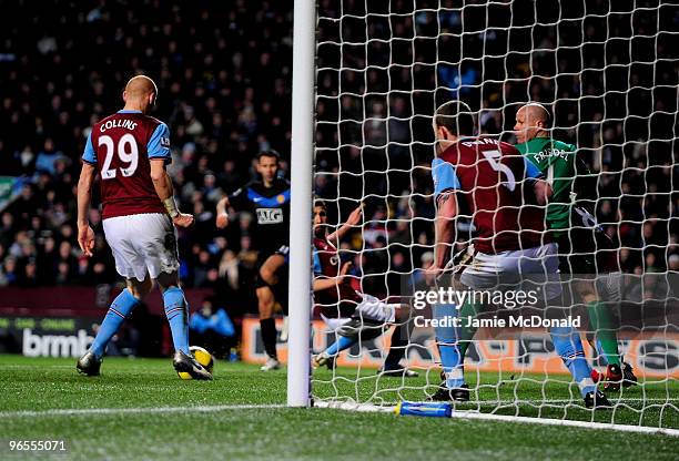 James Collins of Aston Villa scores an own goal from a shot by Ryan Giggs of Manchester United during the Barclays Premier League match between Aston...