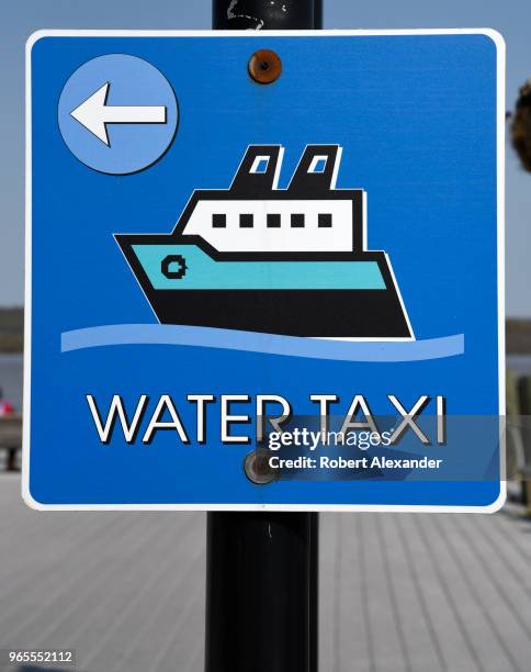 Sign points the way to a Potomac River water taxi in the Old Town section of Alexandria, Virginia.