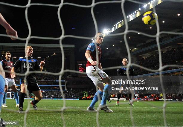 Aston Villa's Welsh defender James Collins scores an own goal during the English Premier League football match against Manchester United at Villa...