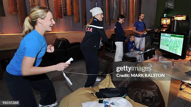 Brianne Lea McLaughlin and Gigi Marvin from the USA Ice Hockey team play a video game as they relax in the Winter Olympic athletes Living Room during...