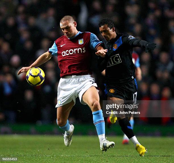 Nani of Manchester United clashes with Luke Young of Aston Villa during the FA Barclays Premier League match between Aston Villa and Manchester...