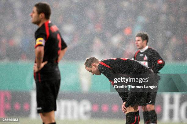 Youssef Mohamad, Miso Brecko and Sebastian Freis of Cologne look dejected after loosing the DFB Cup quarterfinal match between FC Augsburg and FC...