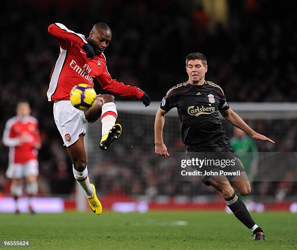 Steven Gerrard of Liverpool competes with William Gallas of Arsenal during the Barclays Premier League match between Arsenal and Liverpool at...