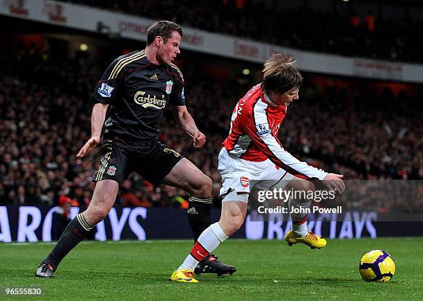 Jamie Carragher of Liverpool competes with Andrey Arshavin of Arsenal during the Barclays Premier League match between Arsenal and Liverpool at...