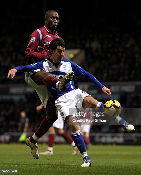 Carlton Cole of West Ham United battles for the ball with Liam Ridgewell of Birmingham City during the Barclays Premier League match between West Ham...