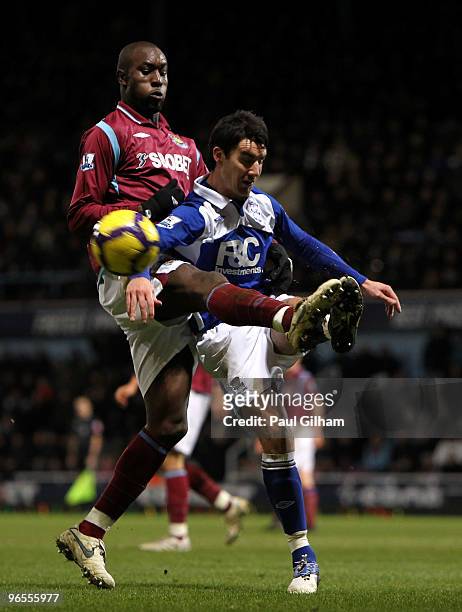 Carlton Cole of West Ham United battles for the ball with Liam Ridgewell of Birmingham City during the Barclays Premier League match between West Ham...
