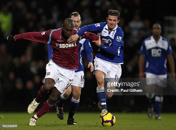 Carlton Cole of West Ham United battles for the ball with Barry Ferguson of Birmingham City during the Barclays Premier League match between West Ham...
