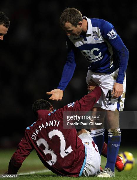 Lee Bowyer of Birmingham City offers help to Alessandro Diamanti of West Ham United after he tackled him during the Barclays Premier League match...