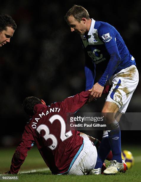 Lee Bowyer of Birmingham City offers help to Alessandro Diamanti of West Ham United after he tackled him during the Barclays Premier League match...
