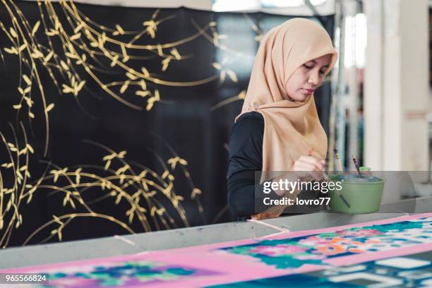 asian woman working in batik workshop - malaysian batik stock pictures, royalty-free photos & images