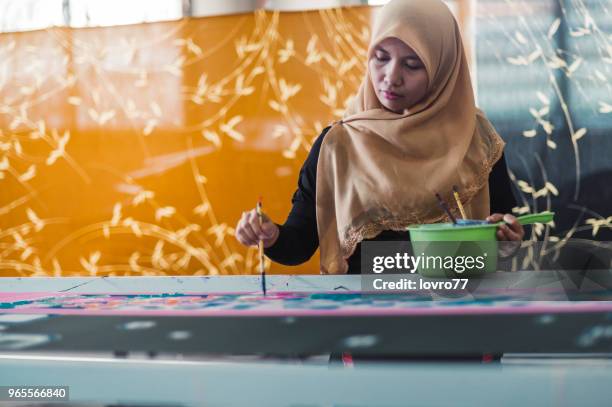 asian woman working in batik workshop - malaysian batik stock pictures, royalty-free photos & images