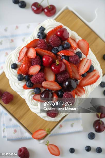 delicious pavlova cake with berries and cherries - iliana mestari stock pictures, royalty-free photos & images