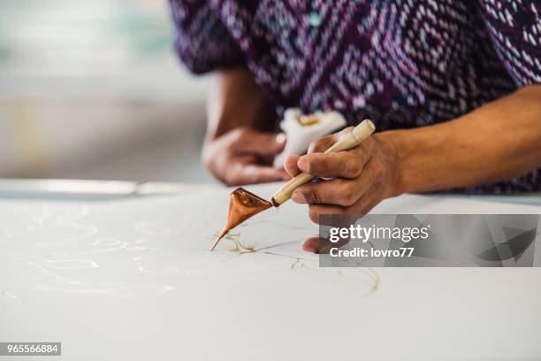 asian man working in batik workshop - malaysia batik stock pictures, royalty-free photos & images