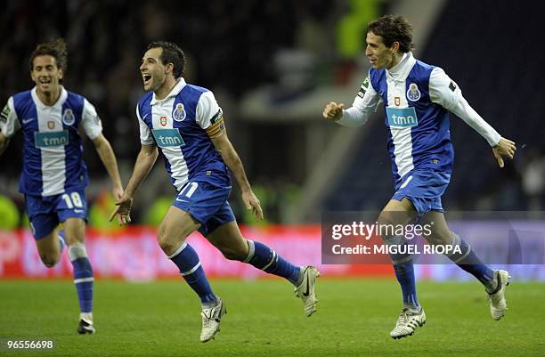 Porto's forward from Argentina Mariano Gonzalez celebrates with team defender Nuno Coelho and midfielder from Argentina Tomas Costa after scoring...