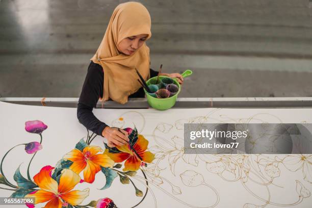 asian woman working in batik workshop - malaysian batik stock pictures, royalty-free photos & images