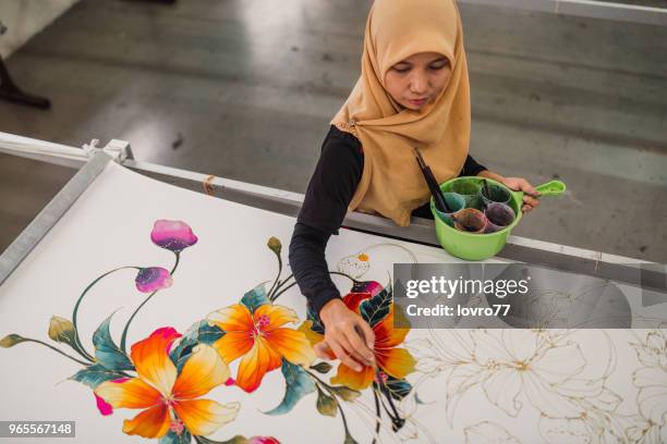 asian woman working in batik workshop - malaysian batik stock pictures, royalty-free photos & images