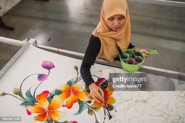 asian woman working in batik workshop - malaysia batik stock pictures, royalty-free photos & images