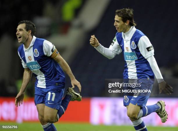 Porto's forward from Argentina Mariano Gonzalez celebrates with teammate midfielder from Argentina Tomas Costa after scoring against Academica during...