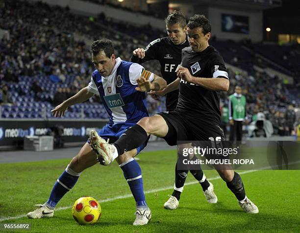 Porto's forward from Argentina Mariano Gonzalez vies with Academica's midfielder Brazilian Diogo Gomes and defender Orlando Neto during their...