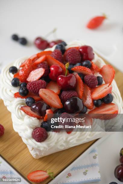 delicious pavlova cake with berries and cherries - iliana mestari stock pictures, royalty-free photos & images