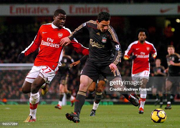 Maxi Rodriguez of Liverpool competes with Emmanuel Eboue of Arsenal during the Barclays Premier League match between Arsenal and Liverpool at...