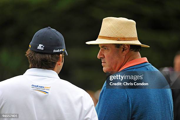 Dallas Cowboys quarterback Tony Romo talks to sports announcer Chris Berman during the 3M Celebrity Challenge at the AT&T Pebble Beach National...