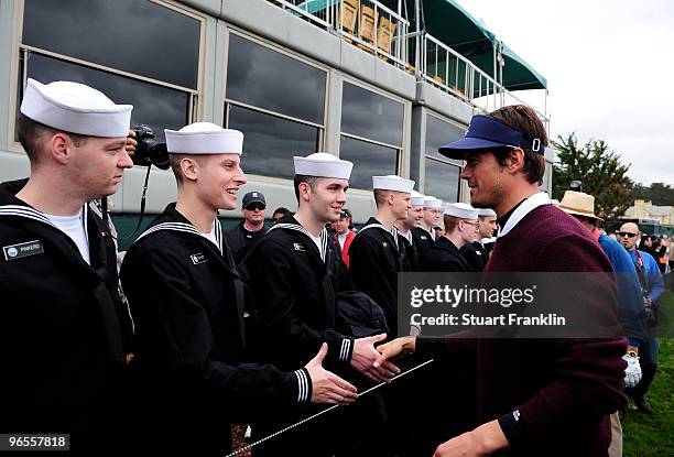 Josh Duhamel greets U.S. Navy personnel during the 3M Celebrity Challenge at the AT&T Pebble Beach National Pro-Am at Pebble Beach Golf Links on...