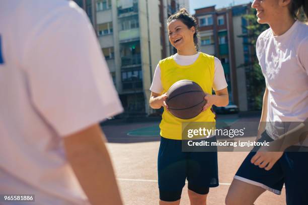 women enjoying on a street court - woman yellow basketball stock pictures, royalty-free photos & images