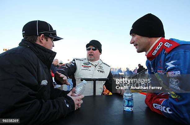 Todd Bodine , driver of the GEICO Toyota, talks with Max Papis , driver of the GEICO Toyota, and Ricky Carmichael , driver of the Monster Energy...