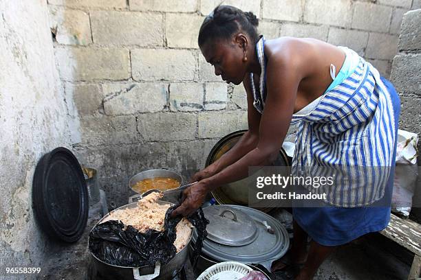 In this handout photo provided by UN PHOTO, members of OJADH open a Kantin, or a small restaurant, to feed children in Bel Air free of charge on...